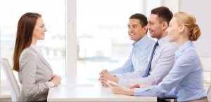 abc1e78c5c0f7ecddf1cbf7bdfbe1e77-e1492116655461-300x146 smiling businesswoman at interview in office