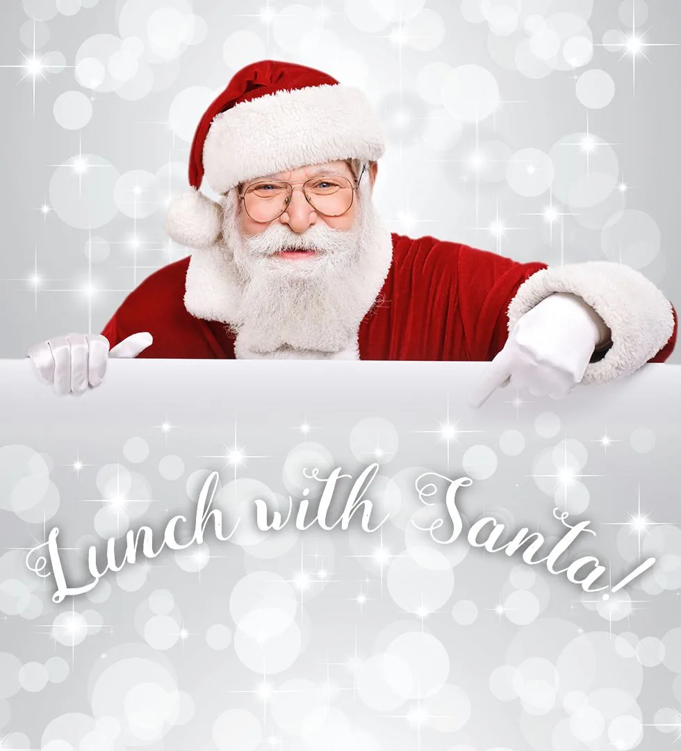 Санта-Клаус указывает на табличку Lunch with Santa.