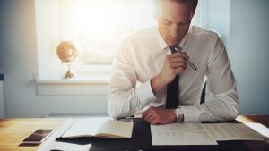 Best-Traits-for-an-Accountant-pic-e1529423065812-300x169 Serious business man working on documents