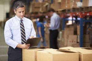 working-as-a-logistics-manager-300x200 Manager In Warehouse Checking Boxes