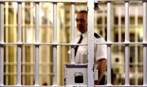 prison-warden-stands-front-cell-300x178 prison-warden-stands-front-cell