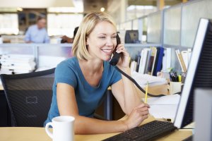 Woman-phone-computer750x500-300x200 Woman On Phone In Busy Modern Office