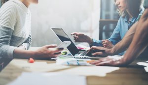 AdobeStock_105374547-300x173 Team succes concept. Businessmans crew working with new startup project. Generic design notebook on wood table.  Analyze plans hands, keyboard. Blurred background, film effect