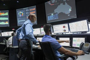 HPE2_0-300x200 Men discussing their work in the security operations center