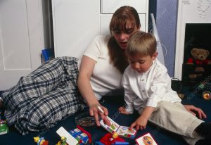 Science-Photo-Library-300x206 Mother smokes while reading with her young boy