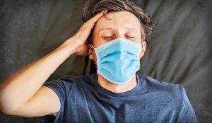 ynews-372166476-300x174 Extremly tired young man lying on the bed, home alone. self-isolation at home, quarantine due to pandemic COVID 19. Mental health problems in self-isolation at home