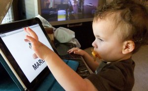child-playing-ipad-e1639774565220-300x185 child-playing-ipad