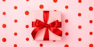 GettyImages-1057635604-1380x690-300x150 Gift box with red bow.