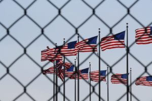 Flags-behind-fence-1200x800-300x200 Flags-behind-fence-1200x800