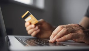 GettyImages-1283516541-e1659555757329-300x172 Shopping online. Young man using laptop with credit card at home