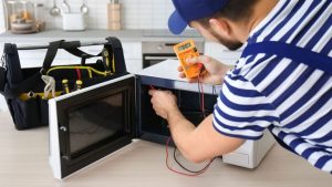 Youngmanrepairingmicrowaveoveninkitchen-Im_842-300x169 Youngmanrepairingmicrowaveoveninkitchen-Im_842
