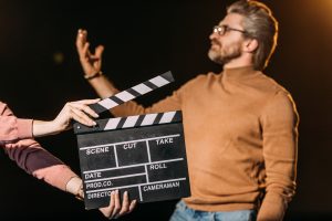 selective-focus-of-mature-actor-performing-role-wi-2022-11-01-23-37-37-utc-300x200 selective focus of mature actor performing role with clapboard in front